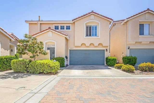 8375 Gold Coast Dr Unit 4, San Diego, CA 92126 - mediterranean / spanish-style house featuring concrete driveway, a garage, stucco siding, and a tiled roof
