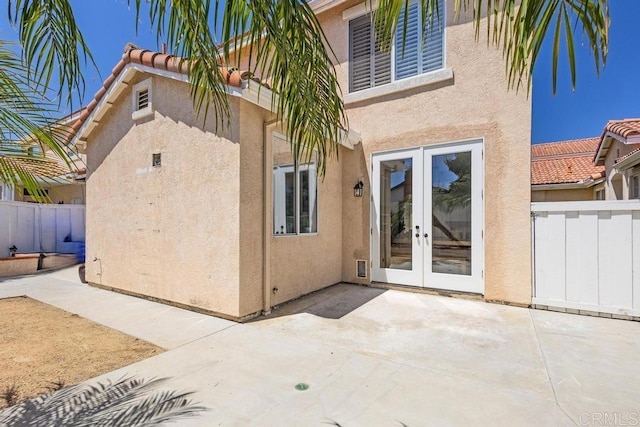 8375 Gold Coast Dr Unit 4, San Diego, CA 92126 - back of property featuring french doors, stucco siding, and a patio area
