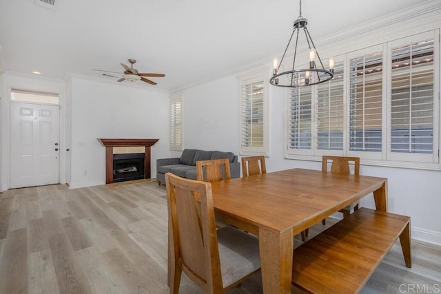 8375 Gold Coast Dr Unit 4, San Diego, CA 92126 - dining space with light wood finished floors, ceiling fan, a chandelier, a fireplace, and ornamental molding
