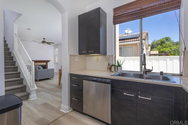 8375 Gold Coast Dr Unit 4, San Diego, CA 92126 - kitchen featuring dishwasher, a sink, and dark cabinets