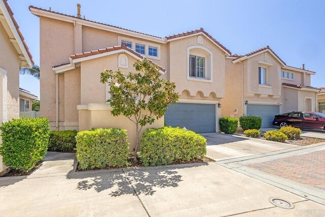 8375 Gold Coast Dr Unit 4, San Diego, CA 92126 - view of front of property with a garage, stucco siding, concrete driveway, and a tiled roof