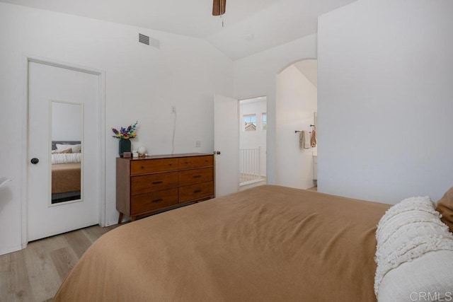 8375 Gold Coast Dr Unit 4, San Diego, CA 92126 - bedroom featuring light wood-style floors, vaulted ceiling, arched walkways, and ceiling fan