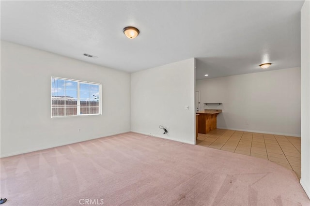7841 Fernwood Ave, California City, CA 93505 - unfurnished living room with carpet, tile patterned flooring, and baseboards