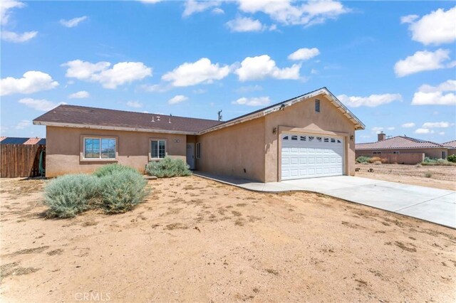 7841 Fernwood Ave, California City, CA 93505 - ranch-style home with a garage, stucco siding, and concrete driveway