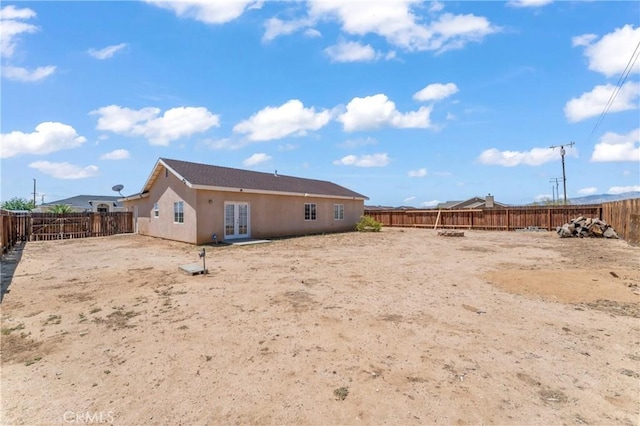 7841 Fernwood Ave, California City, CA 93505 - back of property with french doors, a fenced backyard, and stucco siding