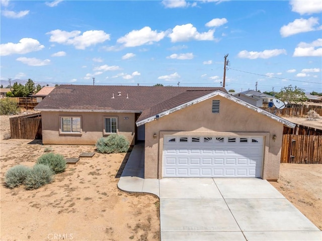7841 Fernwood Ave, California City, CA 93505 - single story home with stucco siding, an attached garage, concrete driveway, and roof with shingles