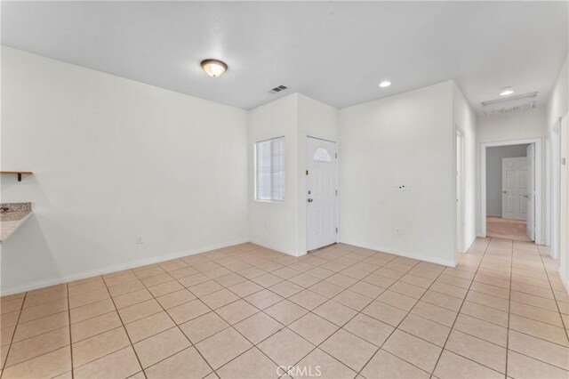 7841 Fernwood Ave, California City, CA 93505 - empty room featuring light tile patterned floors, recessed lighting, and baseboards