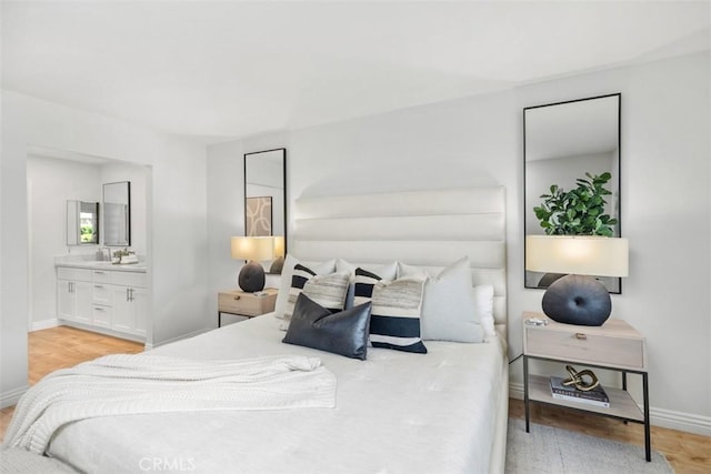 4 Dogwood N, Irvine, CA 92612 - bedroom featuring light wood-style flooring, baseboards, and ensuite bath