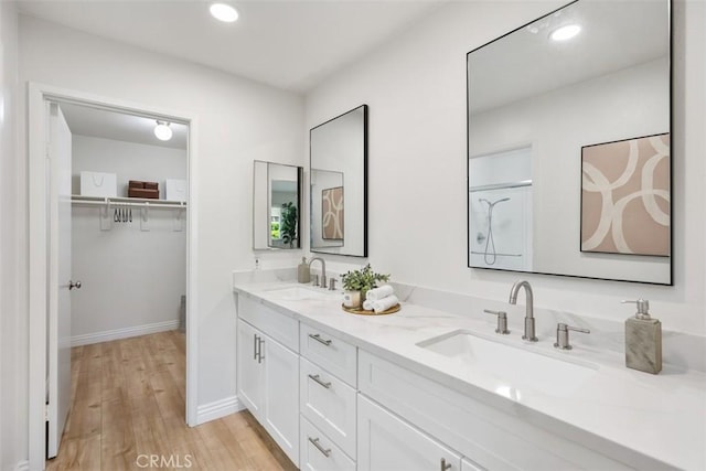 4 Dogwood N, Irvine, CA 92612 - full bathroom with double vanity, wood finished floors, a spacious closet, recessed lighting, and baseboards