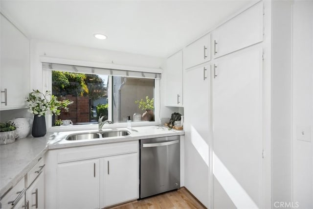 4 Dogwood N, Irvine, CA 92612 - kitchen with stainless steel dishwasher, a sink, light countertops, white cabinets, and light wood finished floors