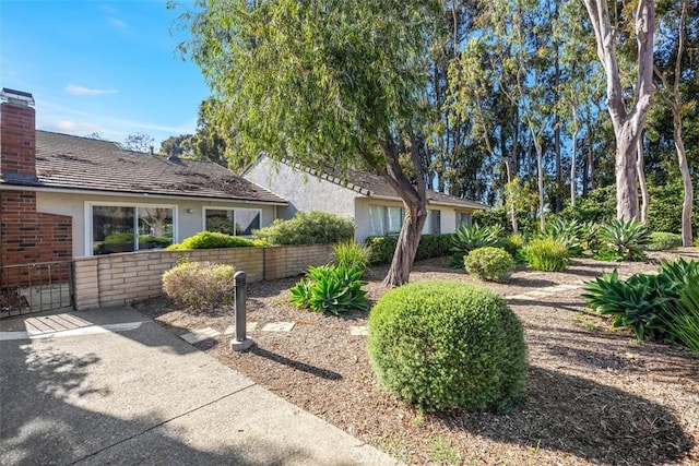 4 Dogwood N, Irvine, CA 92612 - view of front of home featuring stucco siding, a chimney, and brick siding