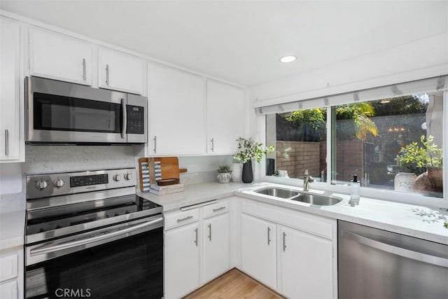 4 Dogwood N, Irvine, CA 92612 - kitchen featuring appliances with stainless steel finishes, a sink, white cabinetry, and recessed lighting