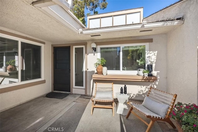 4 Dogwood N, Irvine, CA 92612 - property entrance with a patio area and stucco siding
