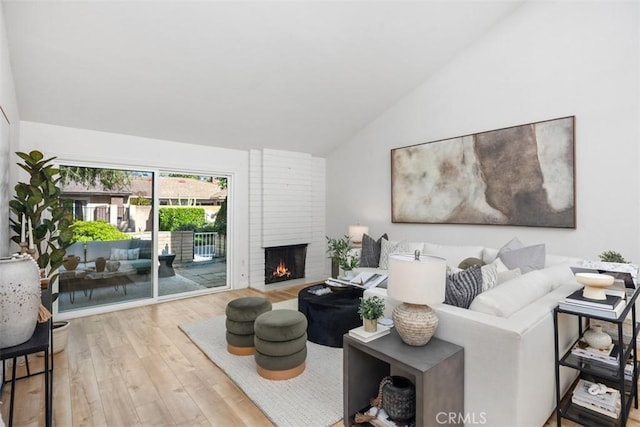 4 Dogwood N, Irvine, CA 92612 - living area with lofted ceiling, wood finished floors, and a fireplace