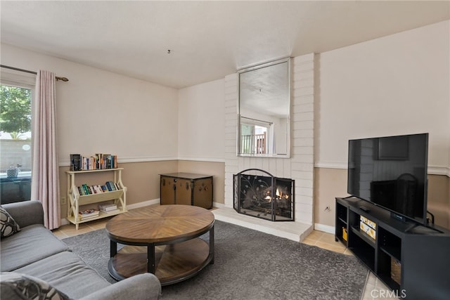 2619 S Castle Harbour Ave, Ontario, CA 91761 - tiled living area with a fireplace and baseboards