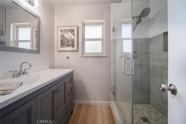 2619 S Castle Harbour Ave, Ontario, CA 91761 - bathroom with plenty of natural light, a shower stall, vanity, and wood finished floors