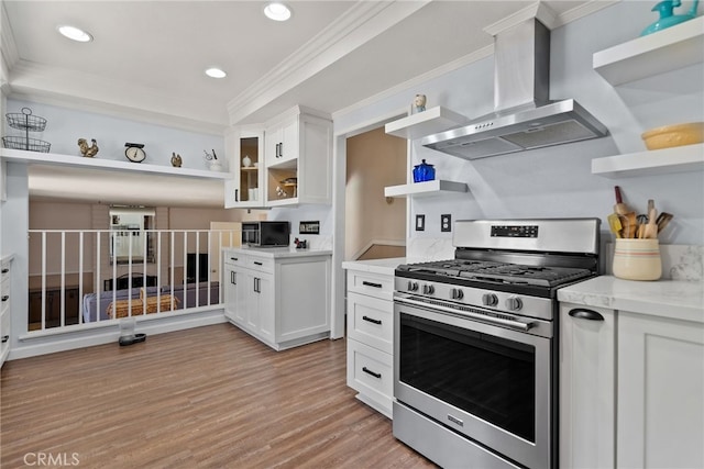 2619 S Castle Harbour Ave, Ontario, CA 91761 - kitchen with open shelves, stainless steel appliances, wall chimney range hood, white cabinets, and ornamental molding