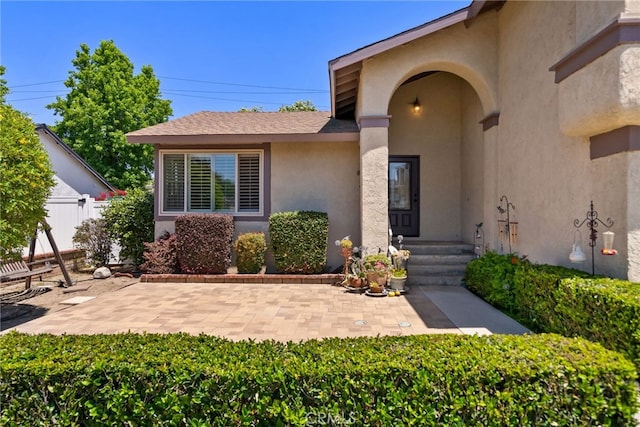 2619 S Castle Harbour Ave, Ontario, CA 91761 - property entrance with stucco siding and a patio