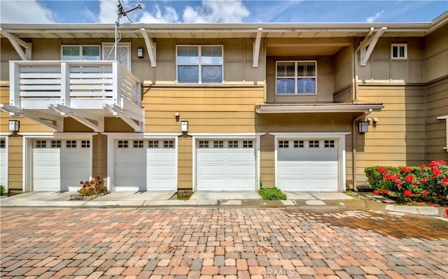 735 Francesca Dr, Walnut, CA 91789 - back of house with an attached garage, a balcony, and driveway