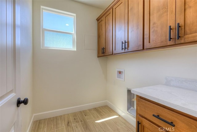 6210 Himmel St, Paradise, CA 95969 - washroom with cabinet space, hookup for a washing machine, baseboards, and light wood-type flooring