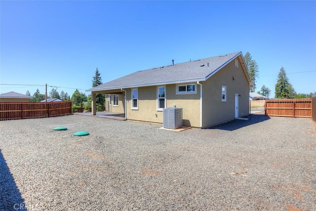 6210 Himmel St, Paradise, CA 95969 - back of property featuring stucco siding, cooling unit, a fenced backyard, and a patio