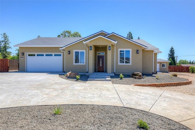 6210 Himmel St, Paradise, CA 95969 - ranch-style home with concrete driveway, an attached garage, and stucco siding