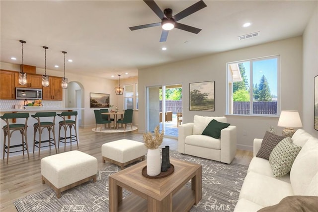 6210 Himmel St, Paradise, CA 95969 - living area featuring light wood finished floors, healthy amount of natural light, recessed lighting, and arched walkways