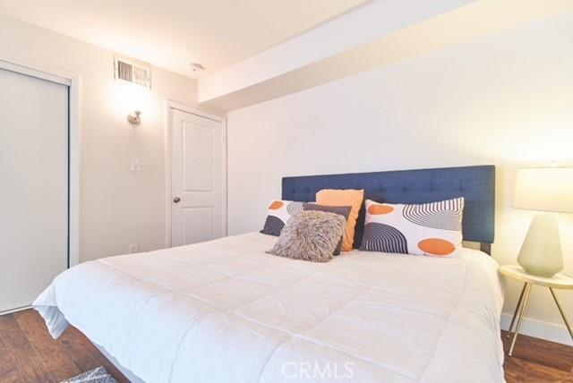 68600 E St, Cathedral City, CA 92234 - bedroom featuring wood finished floors, baseboards, and a closet