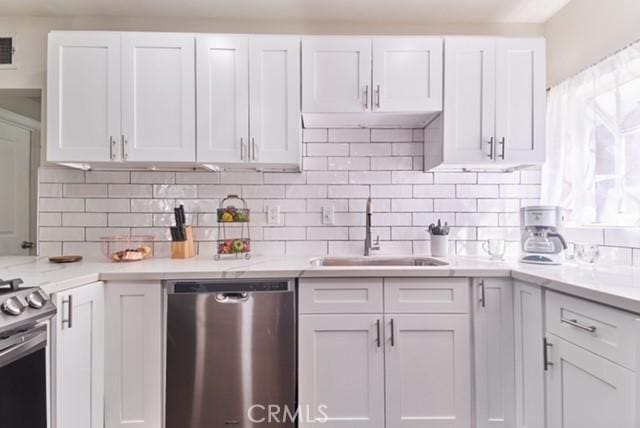 68600 E St, Cathedral City, CA 92234 - kitchen with stainless steel appliances, a sink, white cabinetry, and backsplash