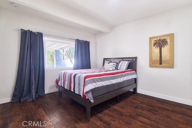 68600 E St, Cathedral City, CA 92234 - bedroom featuring baseboards, wood finished floors, and beam ceiling