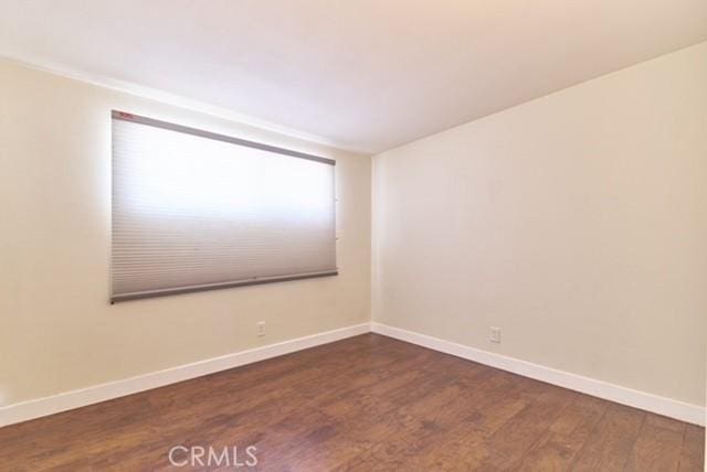 68600 E St, Cathedral City, CA 92234 - unfurnished room with dark wood-style flooring and baseboards