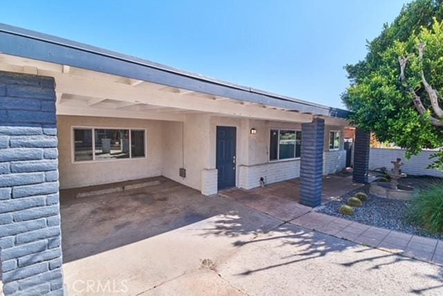 68600 E St, Cathedral City, CA 92234 - view of front facade with a carport and stucco siding