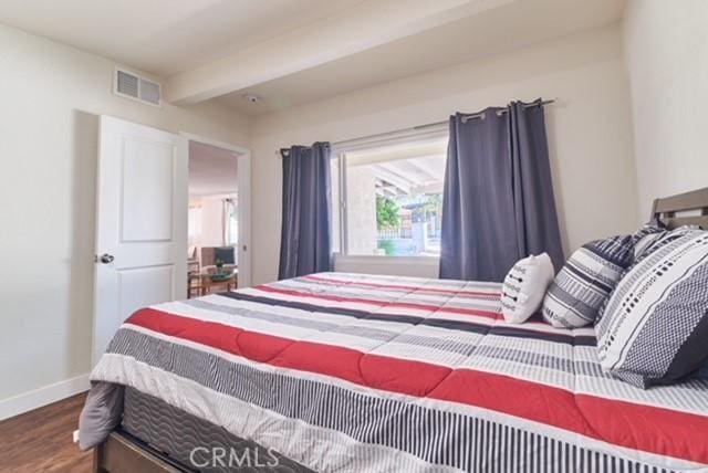 68600 E St, Cathedral City, CA 92234 - bedroom featuring baseboards, wood finished floors, and beam ceiling