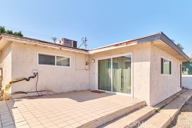 68600 E St, Cathedral City, CA 92234 - rear view of house featuring stucco siding and a patio area