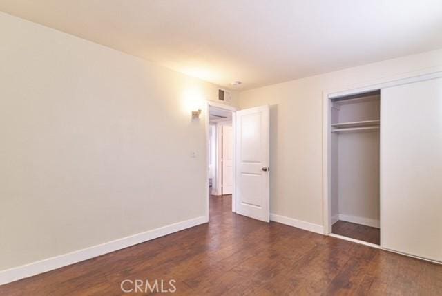 68600 E St, Cathedral City, CA 92234 - unfurnished bedroom with wood finished floors, a closet, and baseboards