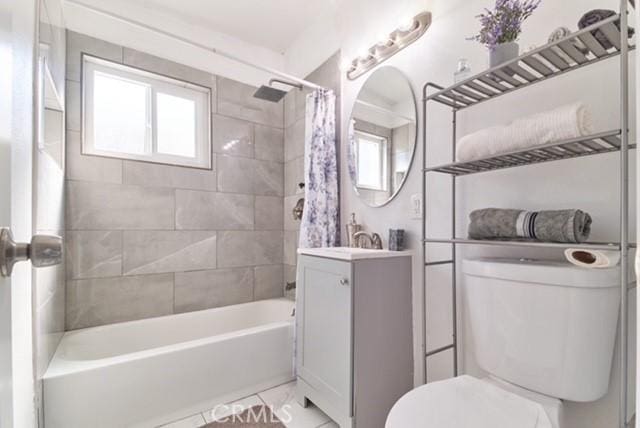 68600 E St, Cathedral City, CA 92234 - full bath featuring toilet, vanity, shower / bathtub combination with curtain, and healthy amount of natural light