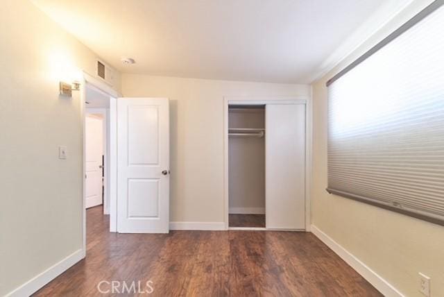 68600 E St, Cathedral City, CA 92234 - unfurnished bedroom with wood finished floors, baseboards, and a closet