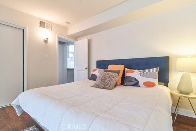 68600 E St, Cathedral City, CA 92234 - bedroom featuring wood finished floors, a closet, and baseboards