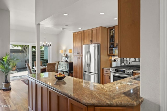 483 Broderick Way, Port Hueneme, CA 93041 - kitchen with stainless steel appliances, brown cabinetry, dark stone counters, glass insert cabinets, and recessed lighting