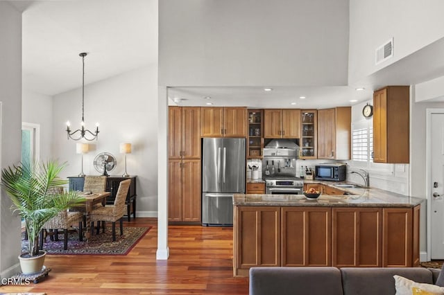 483 Broderick Way, Port Hueneme, CA 93041 - kitchen featuring appliances with stainless steel finishes, brown cabinets, high vaulted ceiling, a chandelier, and wood finished floors