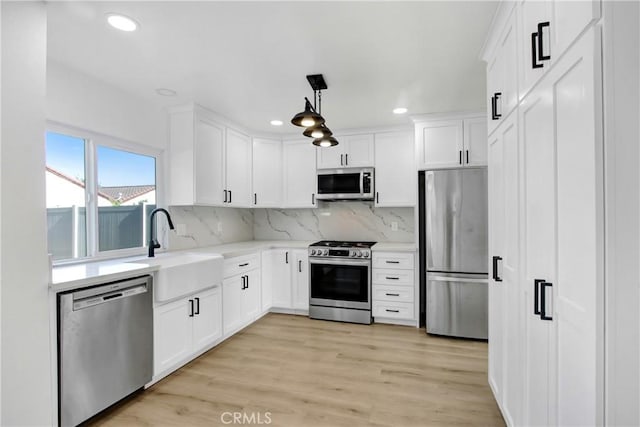 968 N Darfield Ave, Covina, CA 91724 - kitchen featuring appliances with stainless steel finishes, a sink, recessed lighting, white cabinets, and decorative backsplash