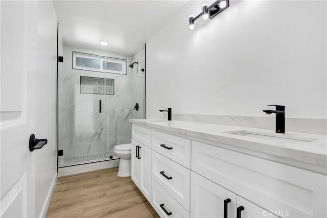 968 N Darfield Ave, Covina, CA 91724 - bathroom featuring a marble finish shower, double vanity, wood finished floors, and toilet