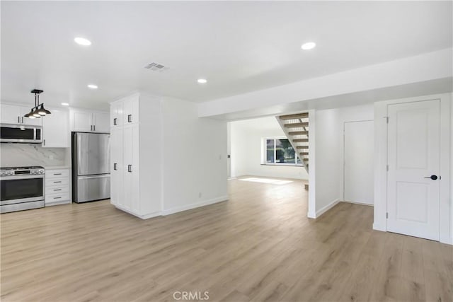 968 N Darfield Ave, Covina, CA 91724 - kitchen featuring appliances with stainless steel finishes, open floor plan, light wood-style floors, white cabinets, and recessed lighting
