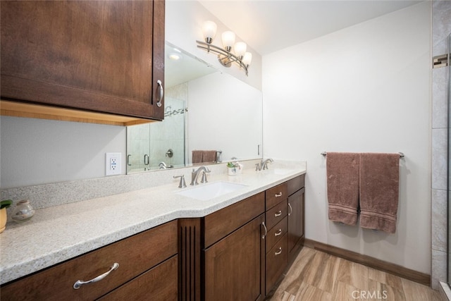 5323 Fidler Ave, Lakewood, CA 90712 - full bath featuring double vanity, wood finished floors, baseboards, and a shower
