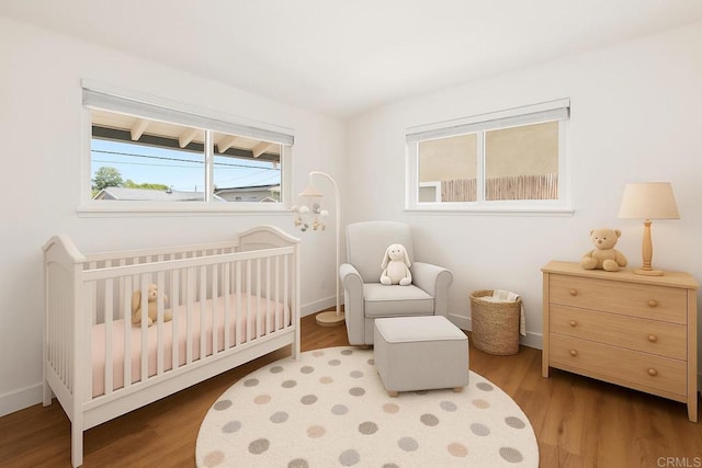 6443 Mount Ackerman Dr, San Diego, CA 92111 - bedroom with wood finished floors, a crib, and baseboards