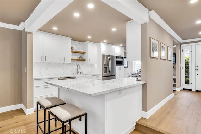 33976 Cape Cv, Dana Point, CA 92629 - kitchen featuring appliances with stainless steel finishes, crown molding, decorative backsplash, recessed lighting, and a peninsula
