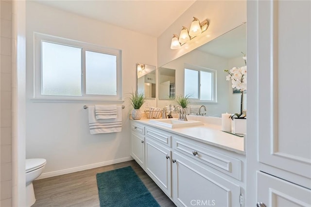 557 S Gardner Dr, Orange, CA 92866 - bathroom with vanity, toilet, wood finished floors, and baseboards