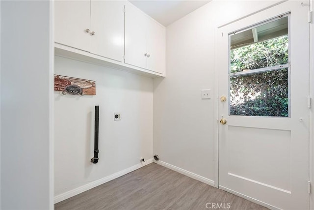 557 S Gardner Dr, Orange, CA 92866 - laundry area with electric dryer hookup, light wood-style floors, cabinet space, and baseboards