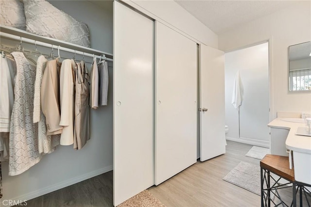 557 S Gardner Dr, Orange, CA 92866 - full bath featuring toilet, wood finished floors, baseboards, and vanity