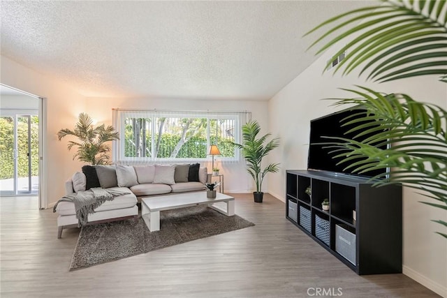 557 S Gardner Dr, Orange, CA 92866 - living area featuring wood finished floors, a textured ceiling, and baseboards